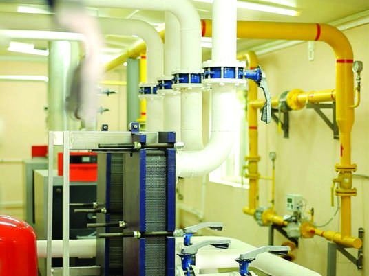 Building plant room with chilled water pipework, valves and pumps