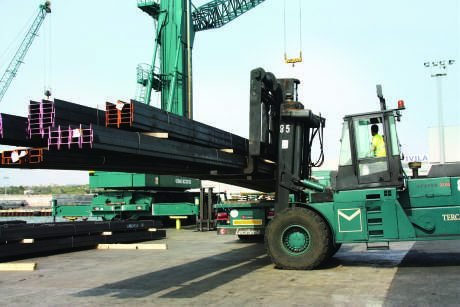 Structural steel sections being handled by forklift in the yard